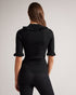 KATELLA-Knitwear-Made of stretchy knit, KATELLA is the perfect statement top to take you from season to season in style. With an oh-so-cute ruffle trim and a super soft feel, this fitted top is sure to become your new go-to. Ted Baker womenswear collection Fitted top Stretch fabric High neck Neck ruffle Ribbed knit Short sleeves with ruffle trim Amy is 5'9.5" / 1.77m and wears Black in a Ted size 1- Ted Baker Romania
